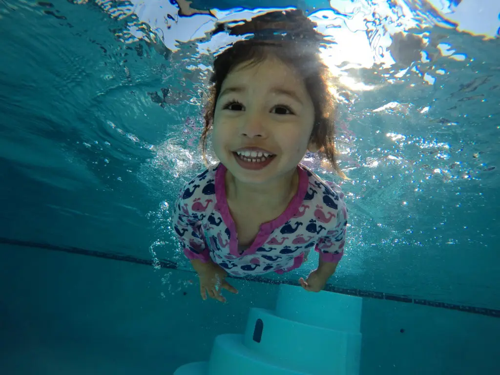 A girl kid swimming under water