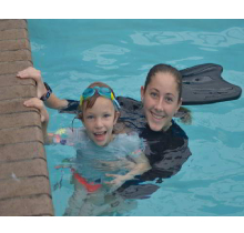A Lady Swimming trainer with kid in the pool