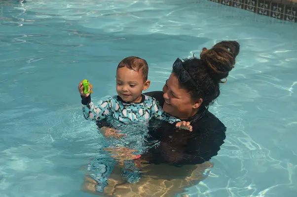 A Swimming trainer with a kid